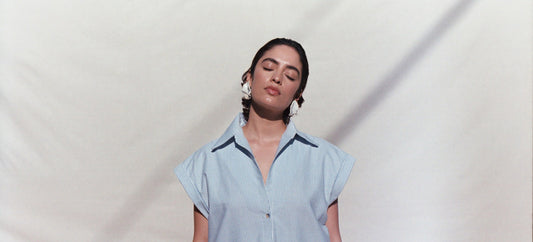 Woman standing in blue shirt dress