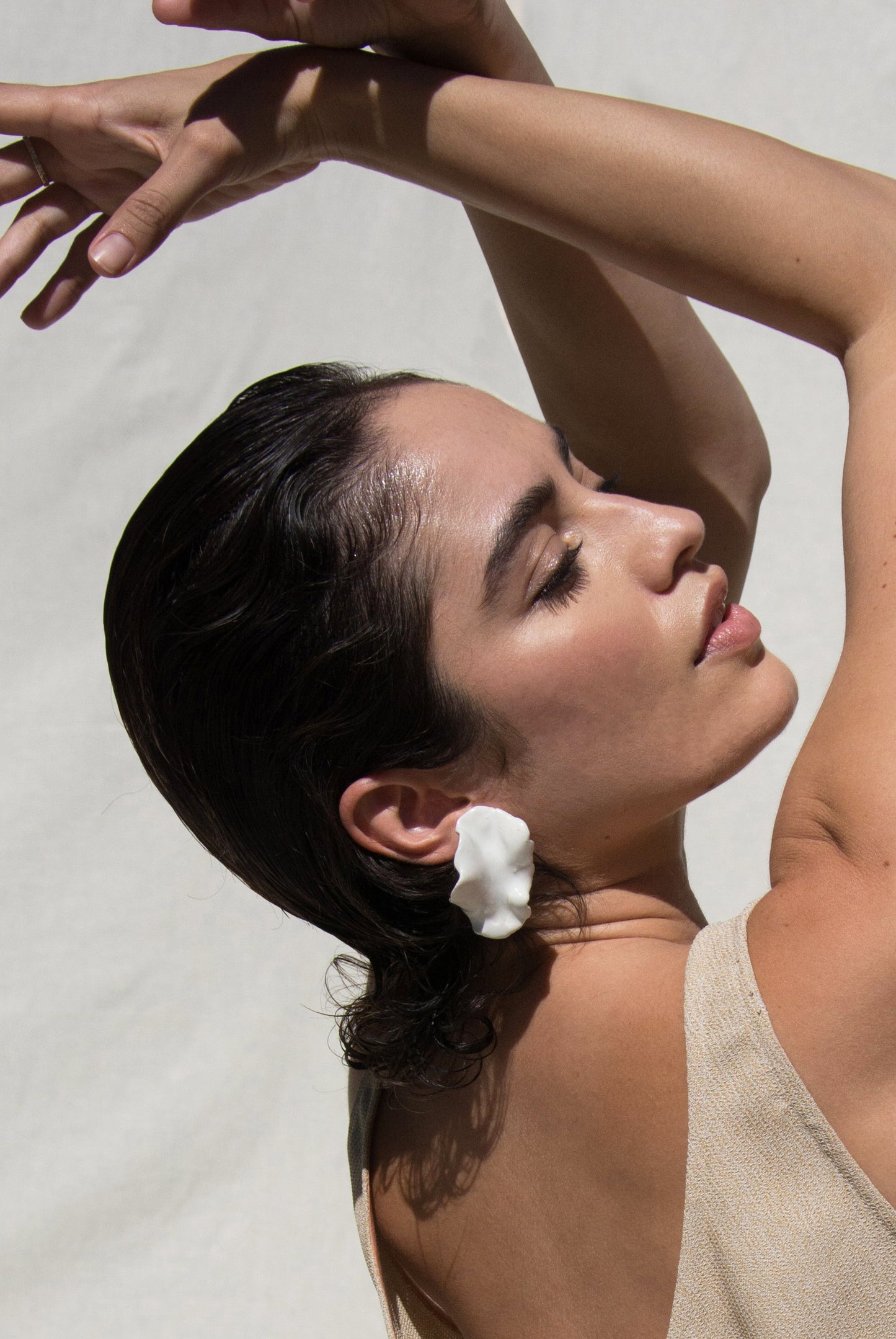 Model wearing White Earring.